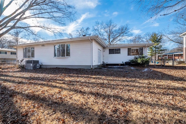 rear view of property with cooling unit