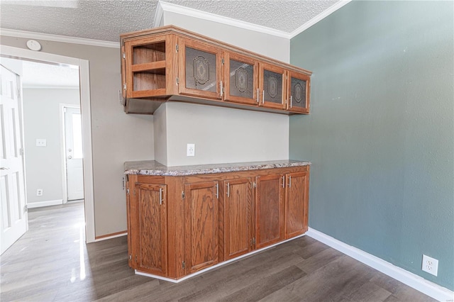 bar featuring crown molding, dark hardwood / wood-style flooring, and a textured ceiling