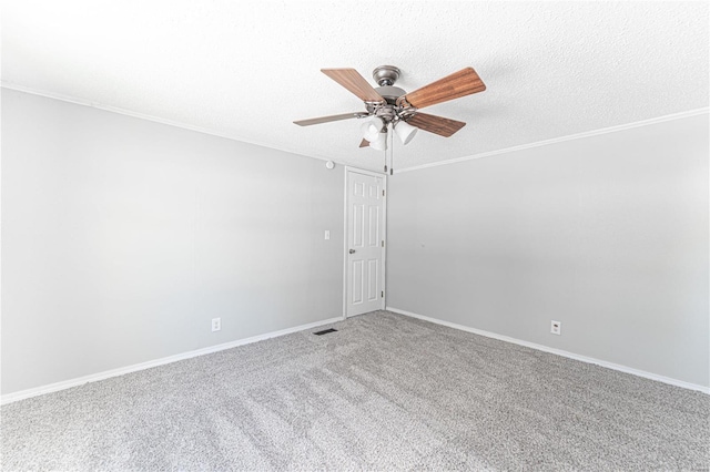 carpeted empty room featuring ceiling fan, ornamental molding, and a textured ceiling