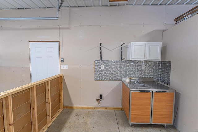 kitchen featuring white cabinets, sink, and stainless steel counters