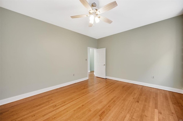 empty room with ceiling fan and light hardwood / wood-style flooring