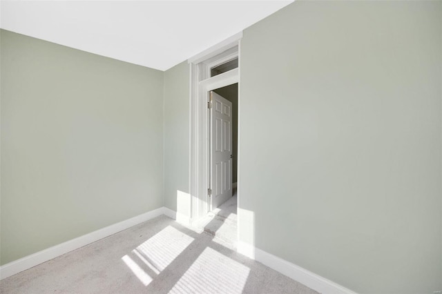 empty room with light carpet and baseboards