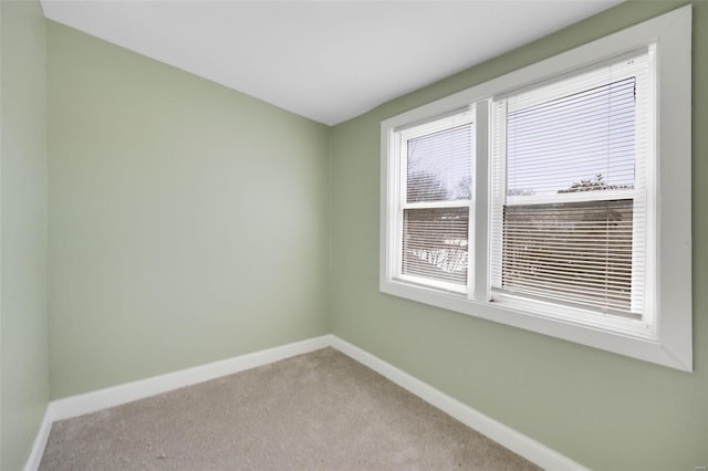 empty room featuring baseboards and carpet floors