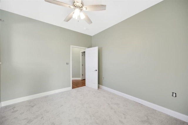 unfurnished room with a ceiling fan, baseboards, and carpet floors