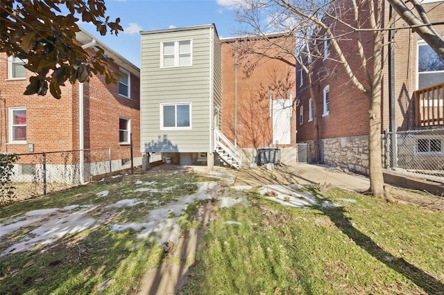 back of house with entry steps and fence