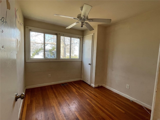 unfurnished room featuring dark hardwood / wood-style floors and ceiling fan