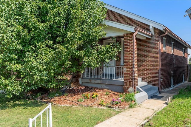 view of side of property with a yard and a porch