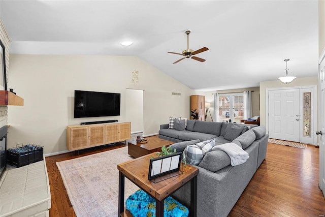 living room with a fireplace, lofted ceiling, hardwood / wood-style floors, and ceiling fan