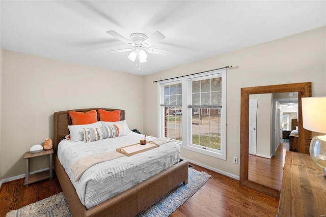 bedroom with ceiling fan and dark hardwood / wood-style floors