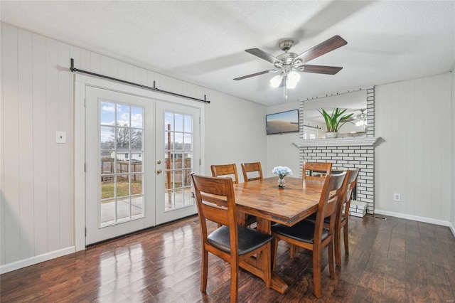 dining room featuring ceiling fan, a textured ceiling, dark hardwood / wood-style flooring, and french doors