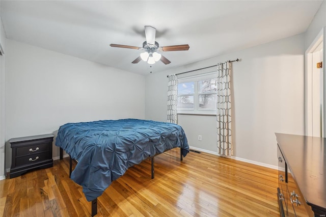 bedroom with ceiling fan and hardwood / wood-style floors