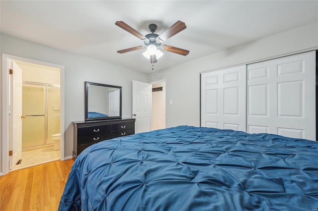 bedroom featuring light hardwood / wood-style flooring, a closet, ceiling fan, and ensuite bathroom