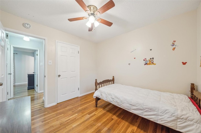 bedroom with light hardwood / wood-style flooring and ceiling fan