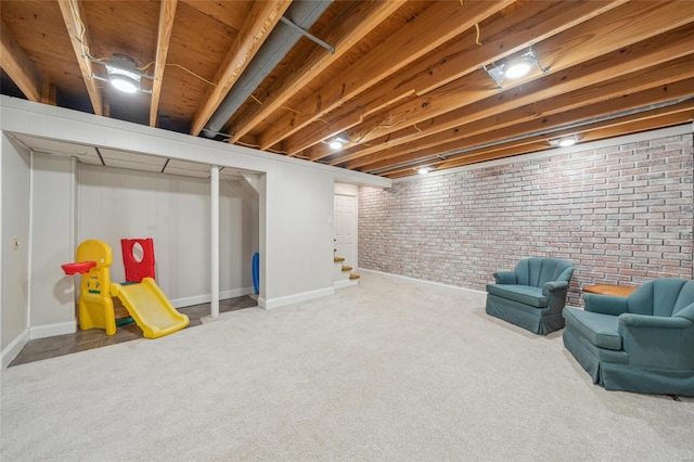 basement with carpet floors and brick wall