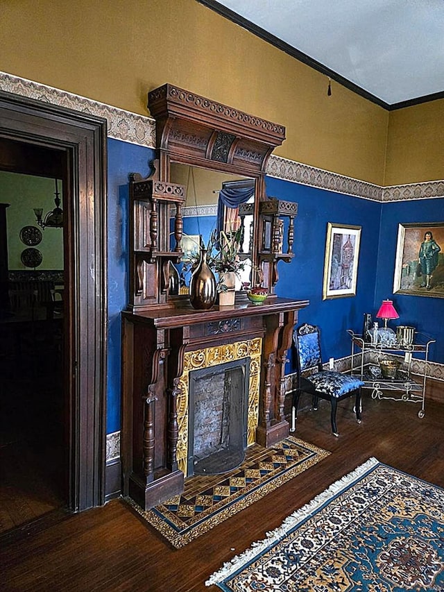 interior space featuring ornamental molding, a fireplace, and hardwood / wood-style floors