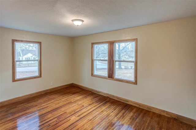 empty room featuring hardwood / wood-style floors and a textured ceiling