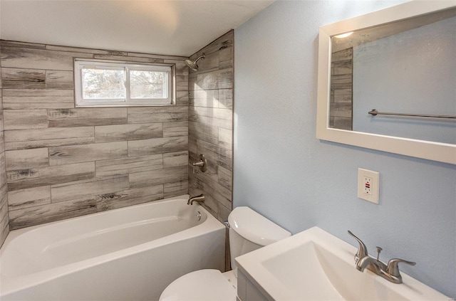 full bathroom with tiled shower / bath, sink, and toilet