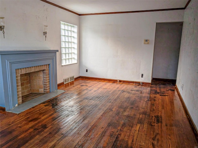 unfurnished living room with ornamental molding, a brick fireplace, and dark hardwood / wood-style flooring