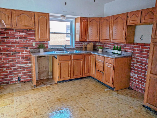 kitchen with brick wall and sink