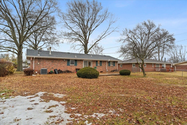 rear view of property featuring central AC