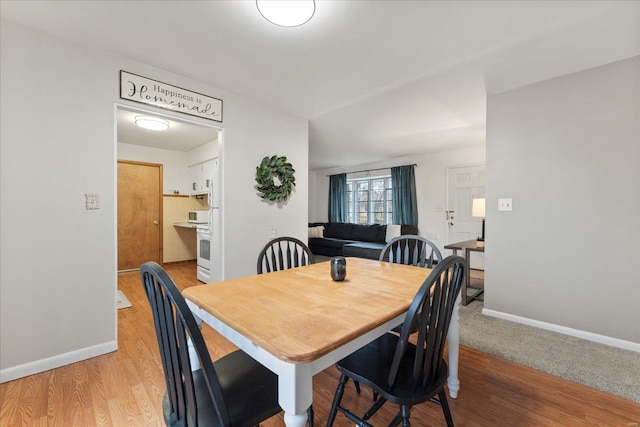 dining area featuring light wood-type flooring