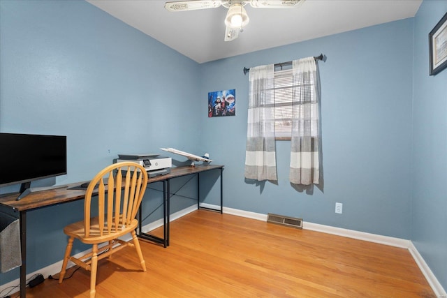 home office featuring hardwood / wood-style flooring and ceiling fan