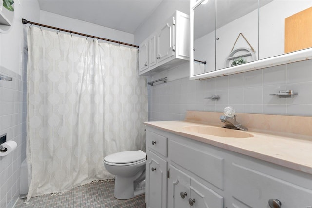 bathroom with vanity, toilet, tile patterned flooring, and tile walls