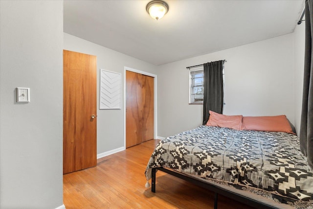 bedroom with light hardwood / wood-style flooring and a closet