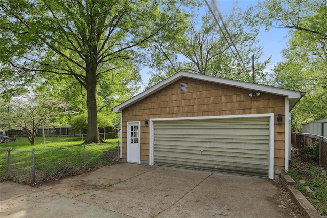 detached garage featuring fence