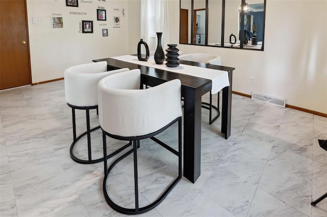 dining room featuring visible vents, marble finish floor, and baseboards