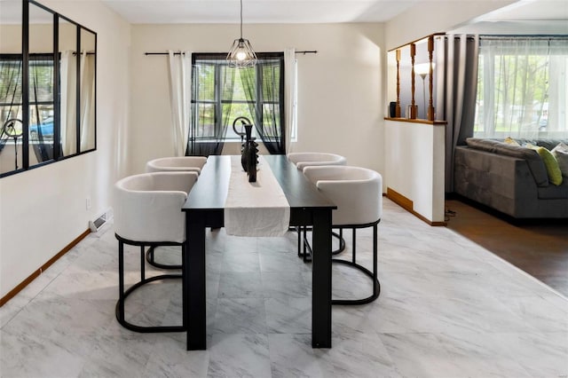 dining room featuring a healthy amount of sunlight, visible vents, and baseboards