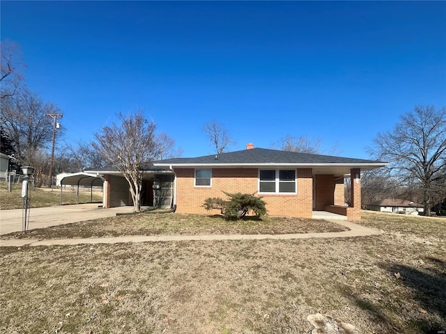 ranch-style house with a carport and a front lawn