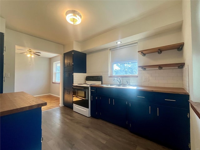 kitchen with blue cabinetry, sink, tasteful backsplash, wooden counters, and white range with electric stovetop