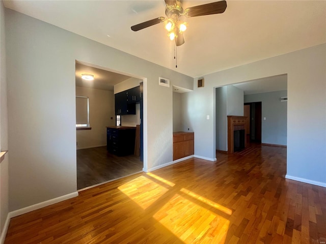 interior space with dark wood-type flooring and ceiling fan