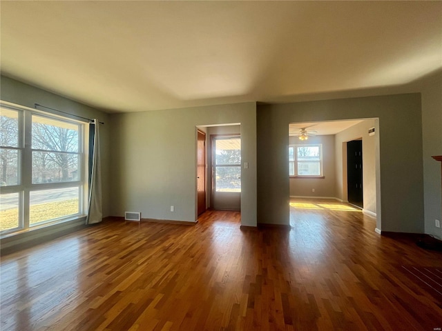 unfurnished room with dark wood-type flooring