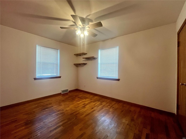 unfurnished room featuring dark hardwood / wood-style flooring, ceiling fan, and a healthy amount of sunlight