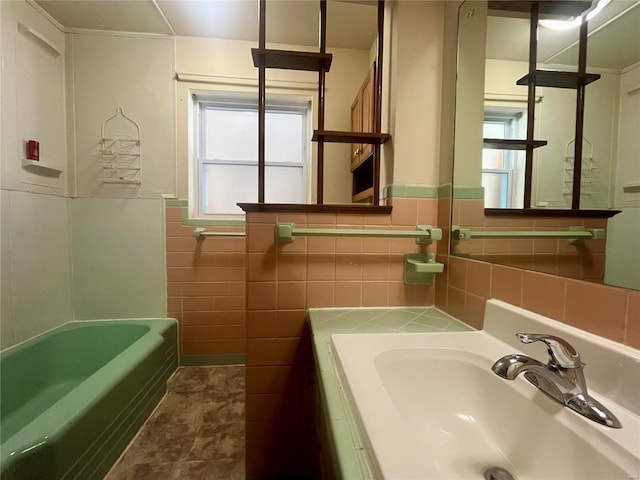 bathroom with sink and tile walls