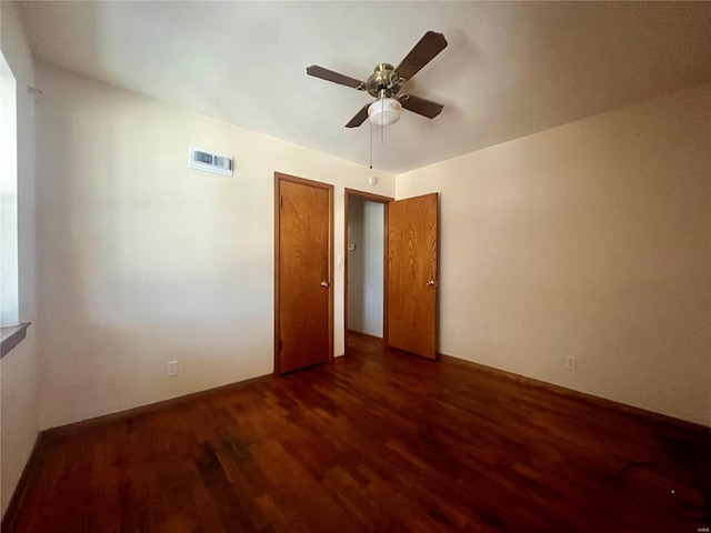 spare room with ceiling fan and dark hardwood / wood-style flooring