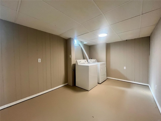 laundry area with washer and dryer and wood walls