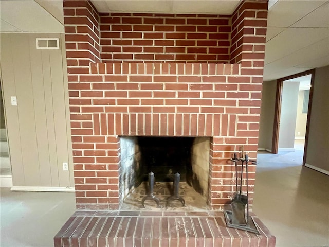 room details with a brick fireplace and wooden walls