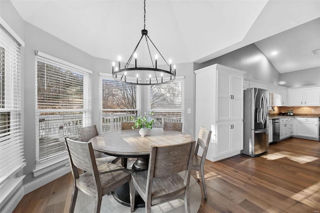 dining room featuring a notable chandelier, high vaulted ceiling, and dark hardwood / wood-style floors