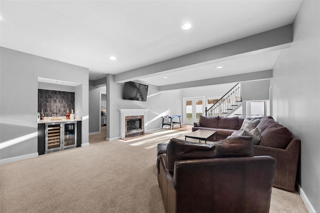 living room with light carpet, bar area, beverage cooler, and beam ceiling