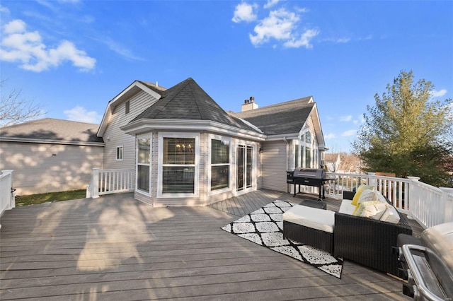 wooden deck with an outdoor living space and grilling area