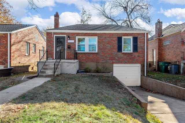 view of front of home with a garage and a front yard