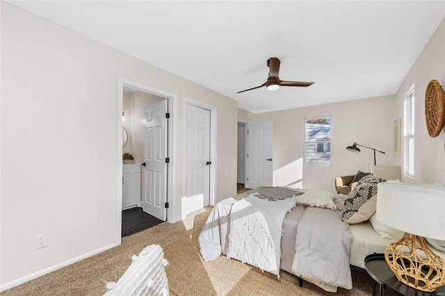 carpeted bedroom with ceiling fan and connected bathroom