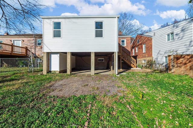 rear view of property featuring a yard and a patio area