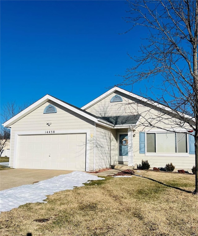 ranch-style home featuring a garage and a front yard