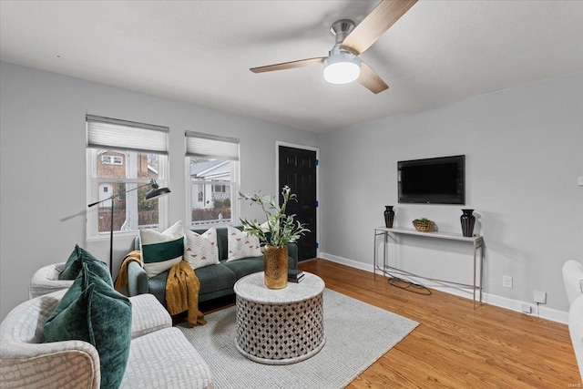 living room featuring hardwood / wood-style floors and ceiling fan