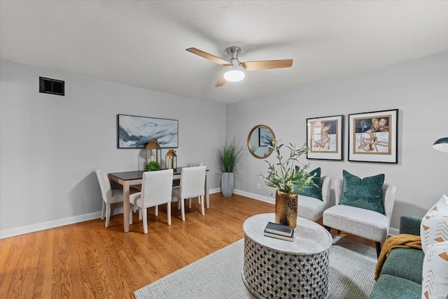 living room featuring ceiling fan and light wood-type flooring