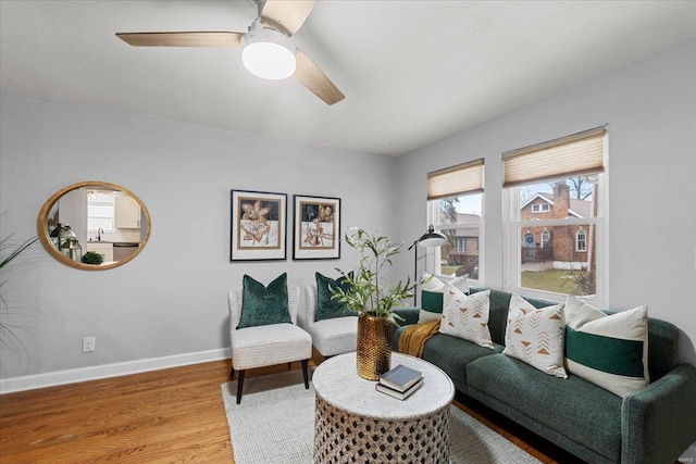 living room featuring hardwood / wood-style flooring and ceiling fan